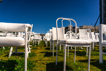 An installation of empty white chairs constitutes an unofficial temporary memorial for 185 people who died in the Canterbury earthquake, memorial in Christchurch New Zealand