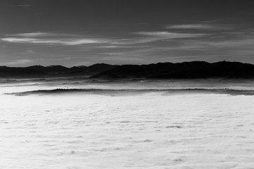 Fog filling a valley in Umbria (Italy), with layers of mountains and hills