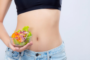 Closeup body beautiful asian woman holding salad vegetable food isolated on white background, girl touch waist and diet vegetarian for healthy, health care or wellness concept.