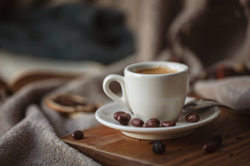 Cup of coffee, a book and wrap: concept of winter relaxation