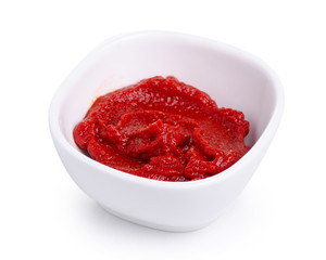 Tomato paste in white bowl on white background isolation