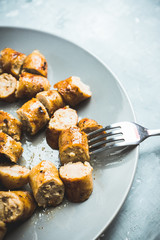 Grilled sliced sausages on plate with classic mustard sauce. Selective focus. Shallow depth of field. 