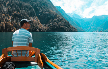Young man looking towards the Alps at the Koenigssee