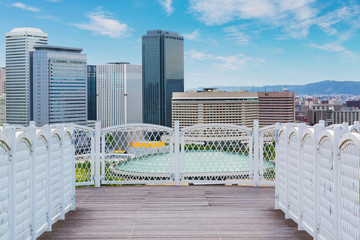 White balcony with perspective wood floor city background.