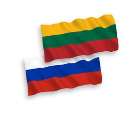 National vector fabric wave flags of Lithuania and Russia isolated on white background. 1 to 2 proportion.