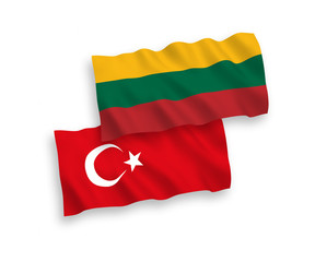 National vector fabric wave flags of Turkey and Lithuania isolated on white background. 1 to 2 proportion.