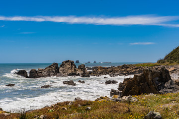 Fototapeta na wymiar amazing coastline at cape foulwind Westport New Zealand, great coast with the waves of the ocean in the background, ocean in new Zealand with great rocks and beach, cape foulwind landscape image