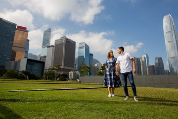 Beautiful young couple posing in yard near city of Hong Kong
