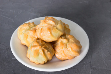 Homemade pastries: profiteroles with butter cream.
