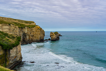 Fototapeta na wymiar photography of tunnel beach in New Zealand, DUNEDIN, NEW ZEALAND Tunnel beach, Dunedin, South island of New Zealand, amazing coast line from above with a drone, Cliff formations at Tunnel Beach