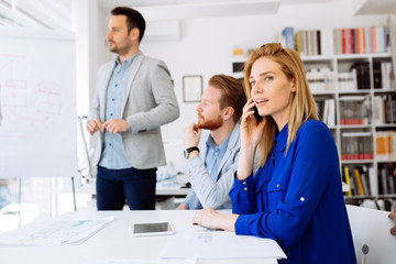 Fototapeta premium Businesswoman working in busy office