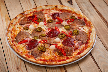 tasty pizza on the wooden background