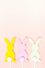 Easter bunnies on pastel pink background