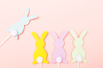 Easter bunnies on pastel pink background