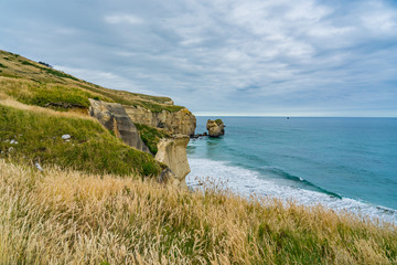 photography of tunnel beach in New Zealand, DUNEDIN, NEW ZEALAND Tunnel beach, Dunedin, South island of New Zealand, amazing coast line from above with a drone, Cliff formations at Tunnel Beach