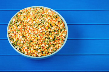 The concept of natural healthy food. Pea grains in a ceramic bowl closeup as food background