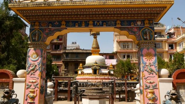 Exterior of aged ornamental Temple. Beautiful ornamental design of gates in oriental style outdoors, bright sunlight. Nepal Lalitpur, Patan Kathmandu. Okubahal Buddha Stupa near Rudra Varna Mahavihar
