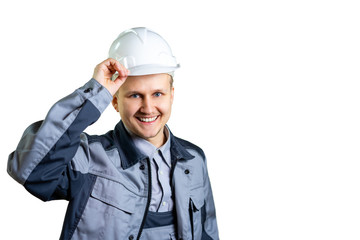 Portrait of a young engineer worker in a white helmet. He greets you on camera. Welcome to the new home. Repair and construction. isolated. Close-up