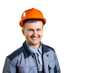 Portrait of a young engineer worker in orange helmet. He is happy ready to go. Repair and construction. isolated. Close-up