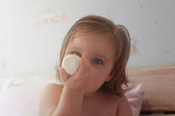Obraz na płótnie Canvas Baby girl using nasal aspirator.