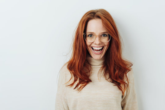 Excited redhead woman wearing glasses