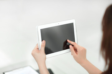 rear view. business woman using digital tablet