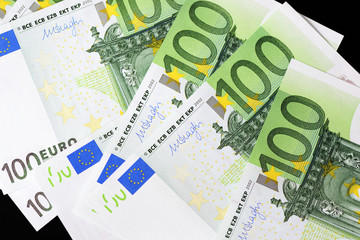One Hundred euro banknotes on a dark background close up