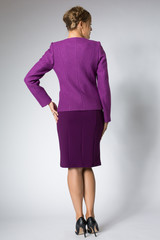 Beautiful blonde girl posing in purple dress