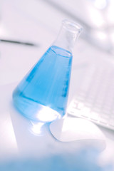 close up.a flask of blue liquid in a science lab