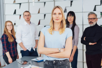 Woman with arms crossed leading the team