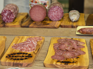 Various Types of Italian Sliced Salami on Wooden Chopping Boards