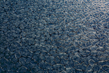 Detail in the natire. Ice in the ocean. Iceberg in North pole. Cold Winter in Arctic. Detail landscape of floating ice on dark sea surface. Evening light on the sea, Svalbard, Norway.