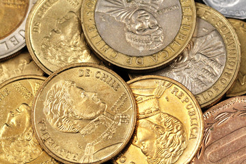 Chilean peso coins in macro on a black reflective surface