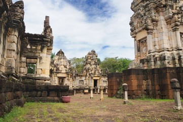 Fototapeta premium Main tower, courtyard and libraries of ancient Khmer temple Prasat Sdok Kok Thom built of red sandstone and laterite in Sa Kaeo province of Thailand