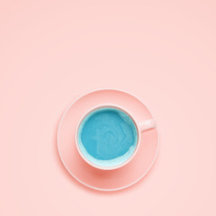 Cup with blue drink, pink background. Minimal style