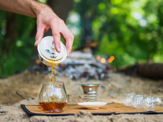 Brewing Chinese tea straits in the woods near the fire