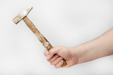 Male hand holds  a old hammer