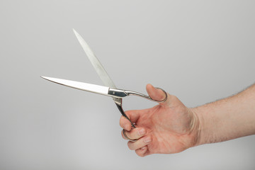 Male hand holds a scissors