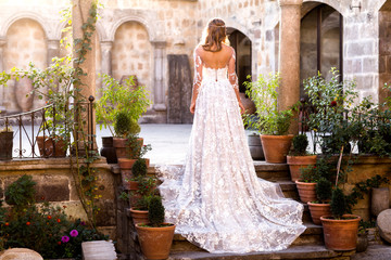 Beautiful bride posing on stairs of old building in Turkey © hreniuca
