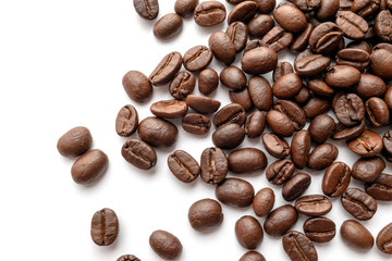 Roasted coffee beans isolated on white background. Close-up.