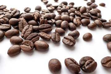 Roasted coffee beans isolated on white background. Close-up.