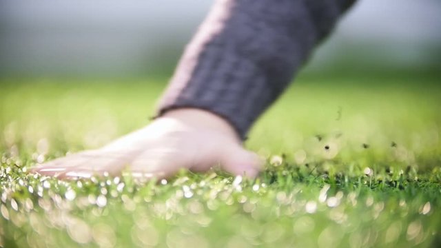 Indoor football arena. A hand palming the artificial grass