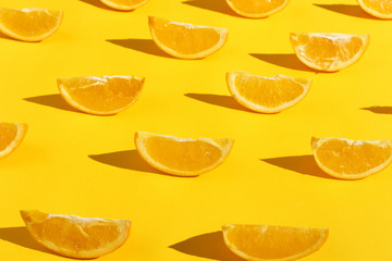 Oranges slices on a yellow background, bright pattern wallpaper.
