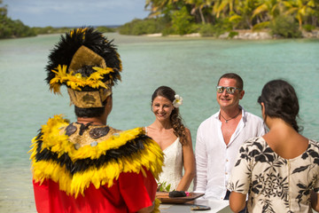Traditional Polynesian wedding in Bora Bora. Gorgeous bride and handsome groom.