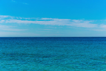 Fototapeta na wymiar Seascape with sea horizon and cloudy sky - background