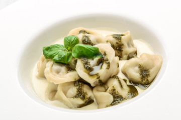 Meat dumplings, ravioli with meat with pesto sauce on plate