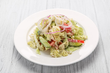 Salad from smoked sausage, spicy carrot, tomato, cucumber and spices, dressed with mayonnaise