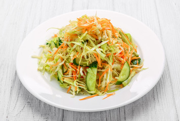 Fresh vegetable salad with cabbage, carrot, green onion and cucumber