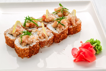 Hot fried Sushi Roll with salmon, avocado and cheese. Japanese food.