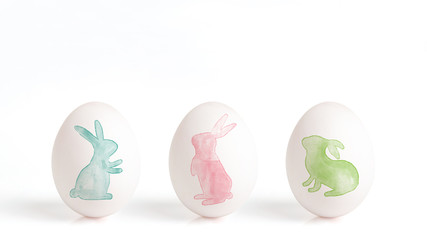 rabbit painted with watercolor on a white egg, easter eggs isolated on a white background,  easter design with cute bunny, hand drawn illustration